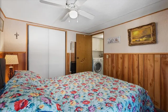 a bedroom with a bed and a chandelier