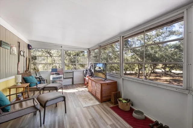 a room with furniture and large windows