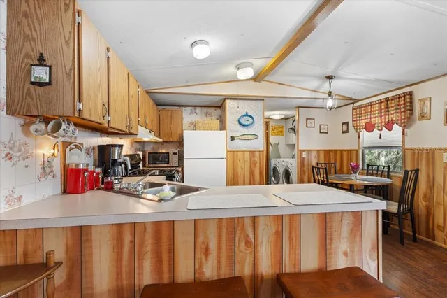 a kitchen with stainless steel appliances granite countertop a sink and cabinets