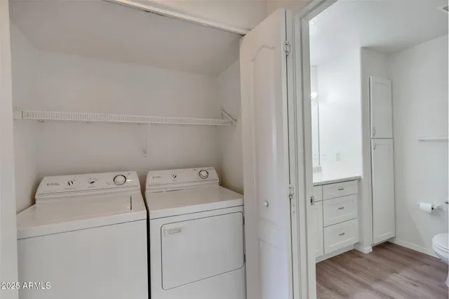 a view of washer and dryer with wooden floor