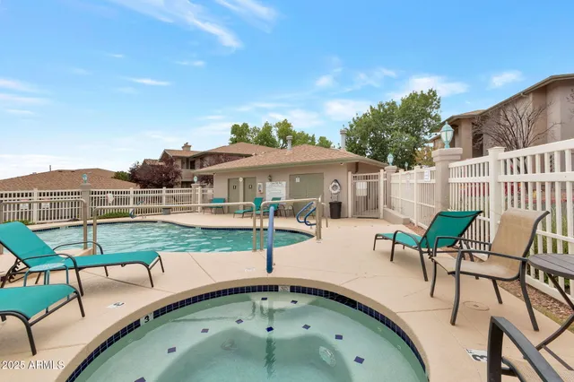 swimming pool view with a seating space