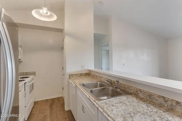 a kitchen with a sink stove and refrigerator