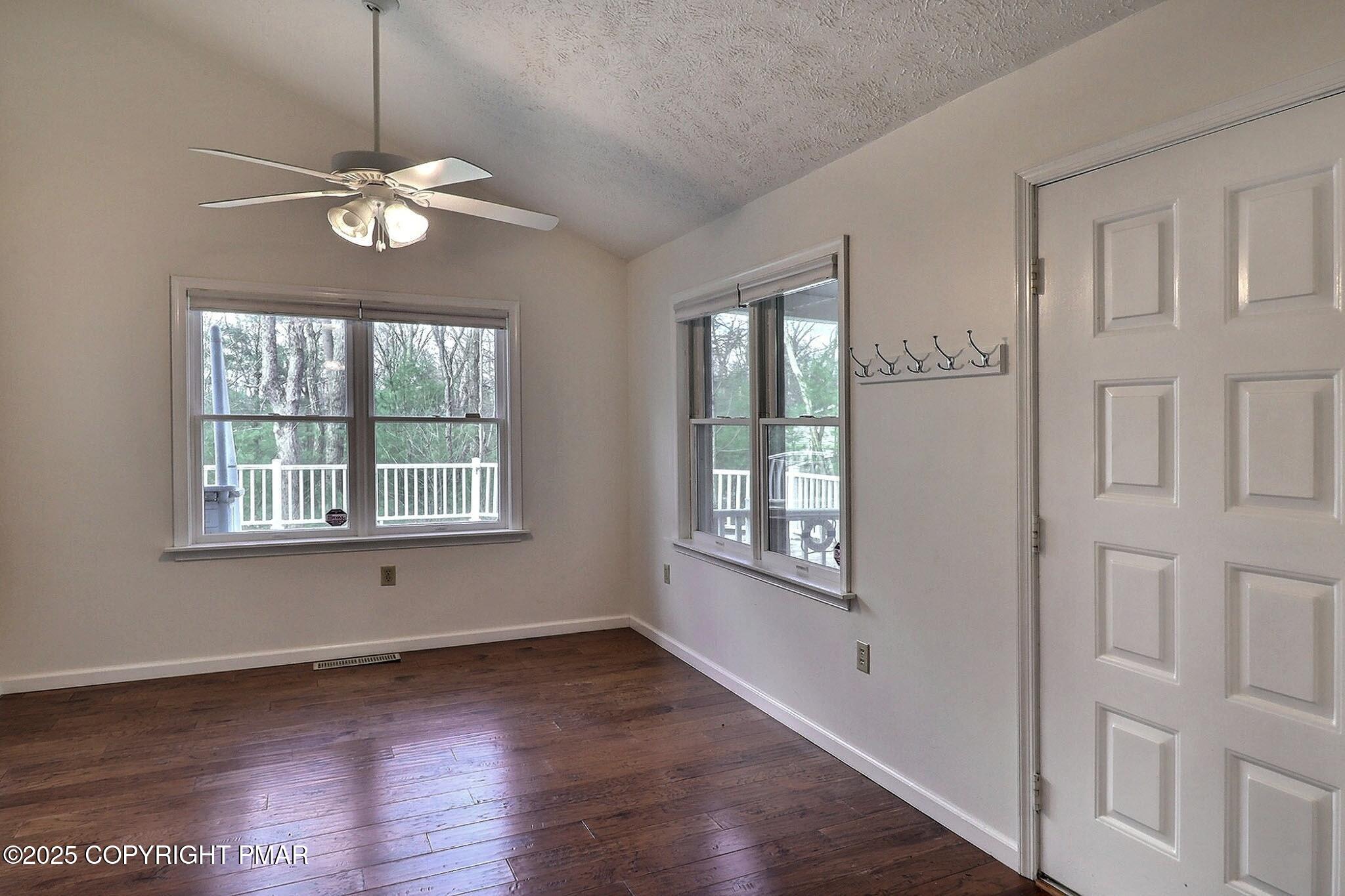 641 Long Mountain Road Effort, PA 18330 - Photo 11 of 41 a view of an empty room with wooden floor and a window