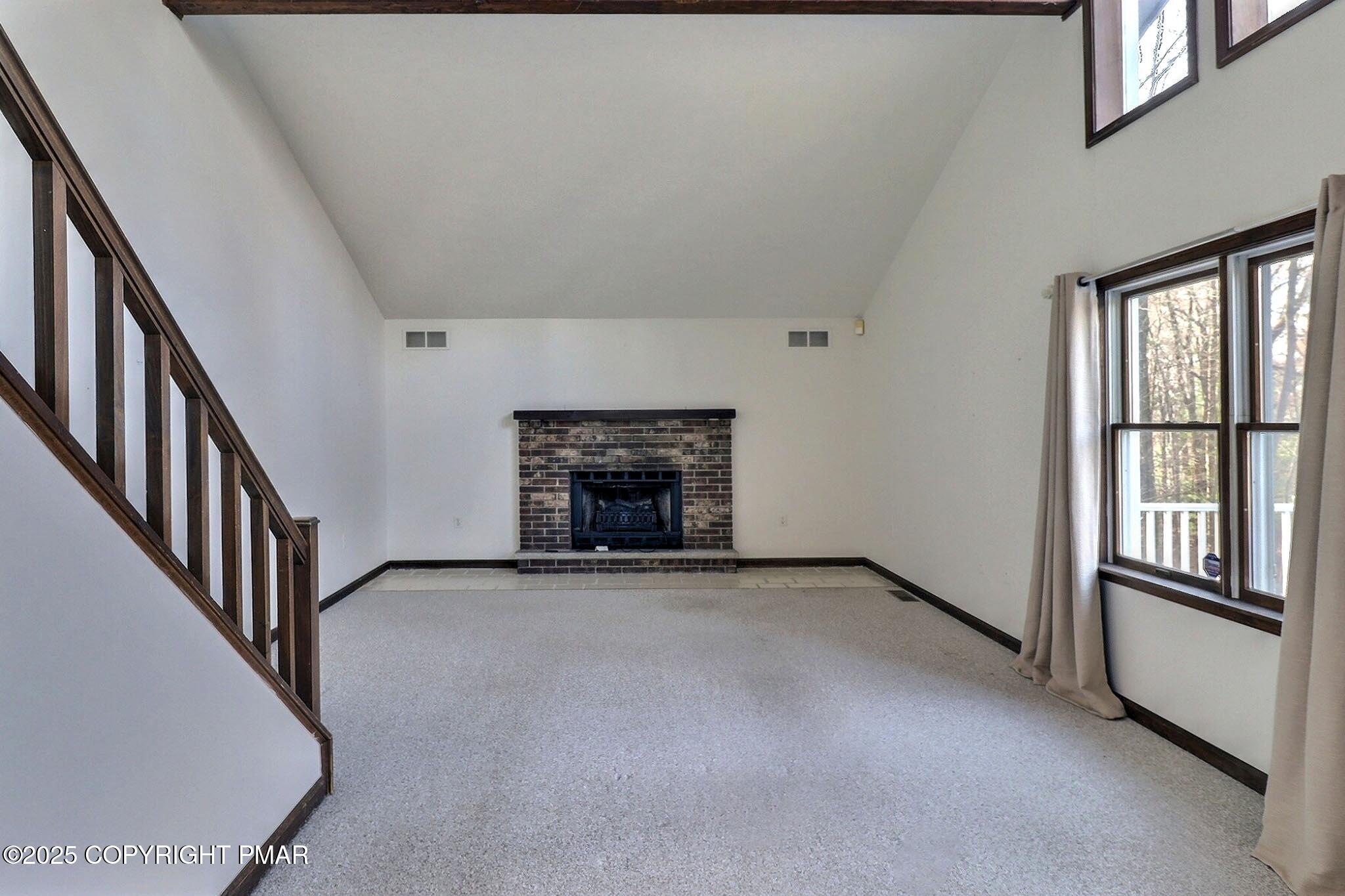 641 Long Mountain Road Effort, PA 18330 - Photo 14 of 41 an empty room with fireplace and windows