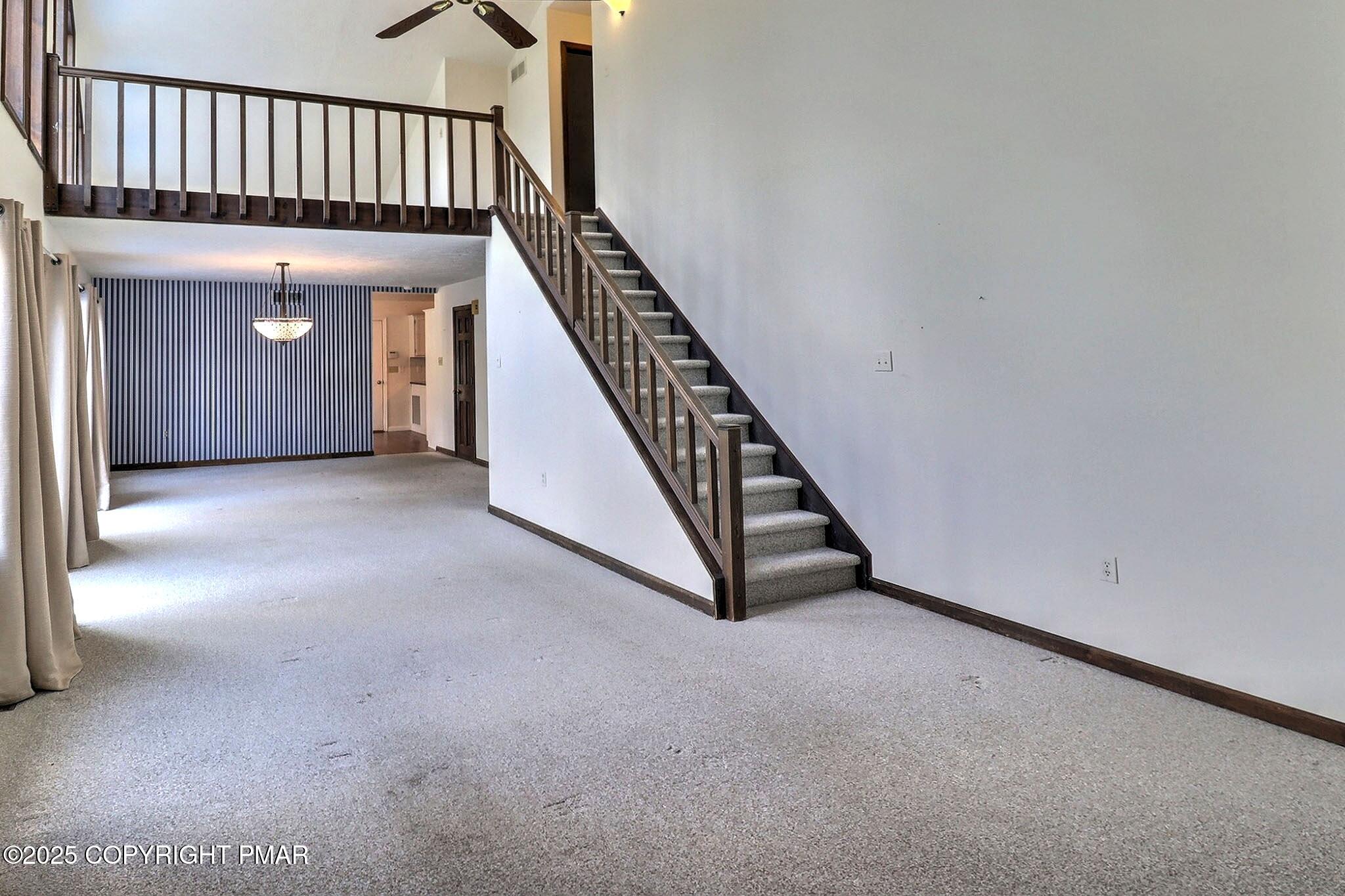 641 Long Mountain Road Effort, PA 18330 - Photo 40 of 41 a view of an empty room with wooden floor and stairs
