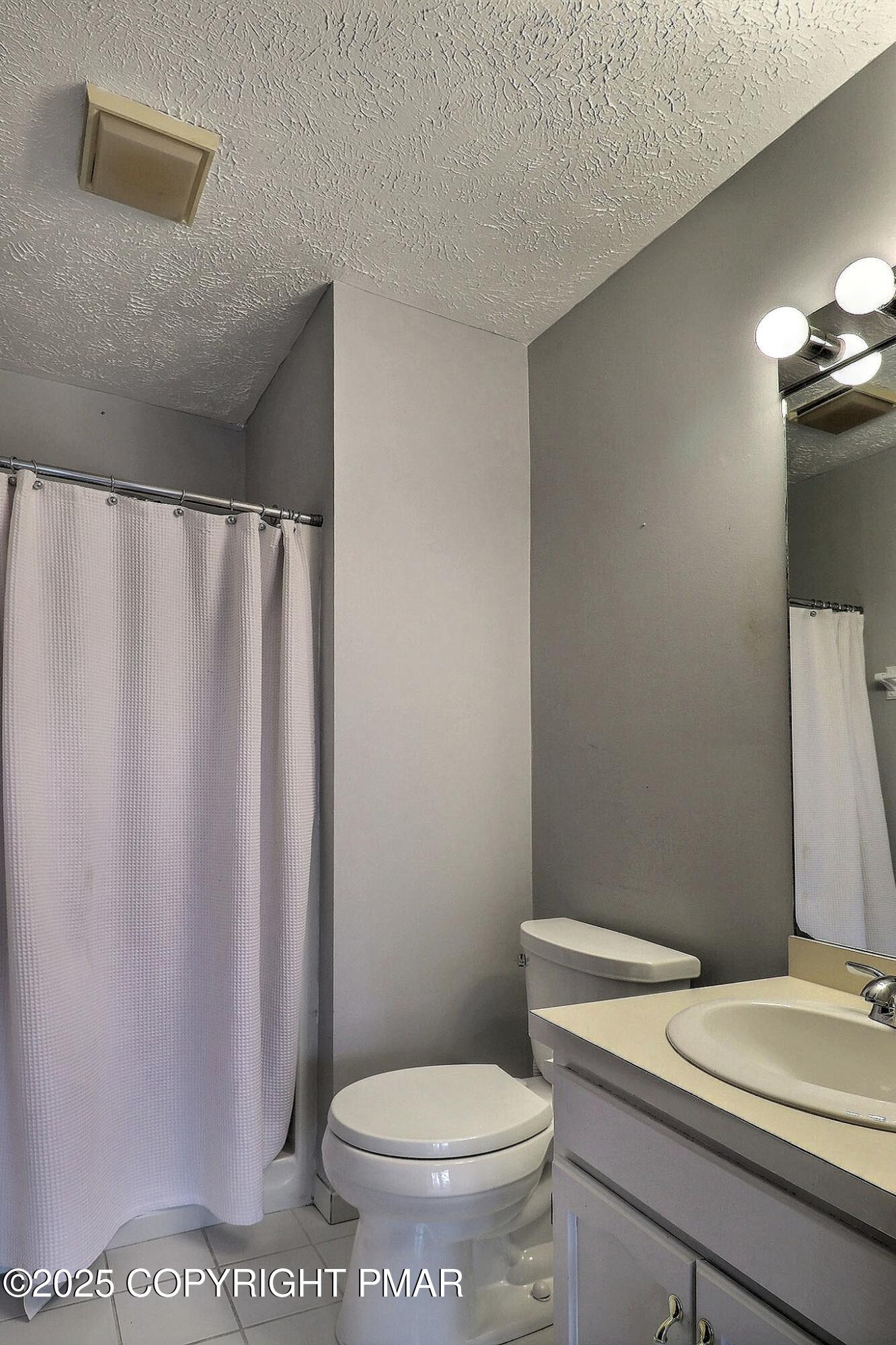 641 Long Mountain Road Effort, PA 18330 - Photo 26 of 41 a white toilet sitting next to a bathroom sink and a shower