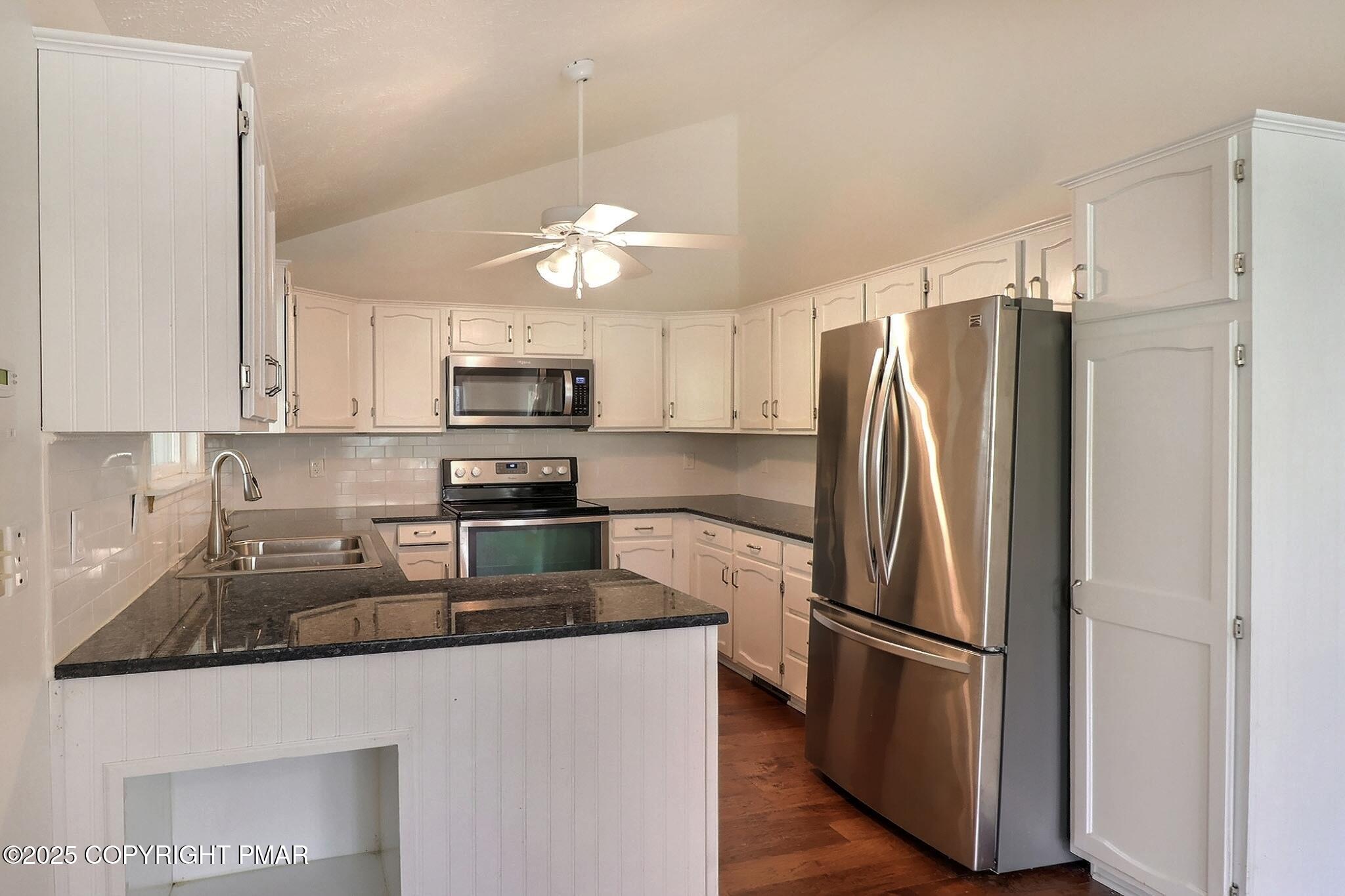 641 Long Mountain Road Effort, PA 18330 - Photo 9 of 41 a kitchen with stainless steel appliances granite countertop a refrigerator a stove top oven a sink and dishwasher