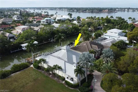 an aerial view of a house with a lake view