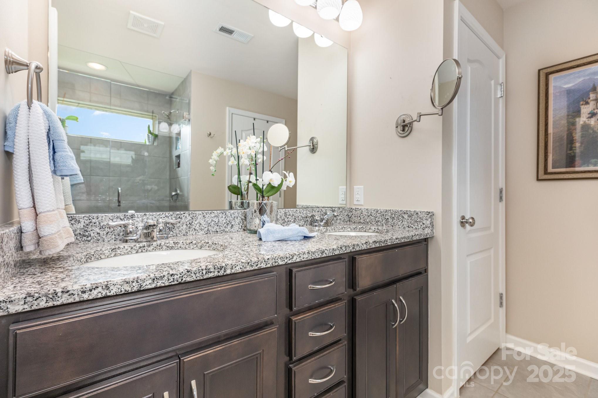 6006 Cadence Lane Fort Mill, SC 29707 - Photo 12 of 19 a bathroom with a granite countertop sink and a mirror