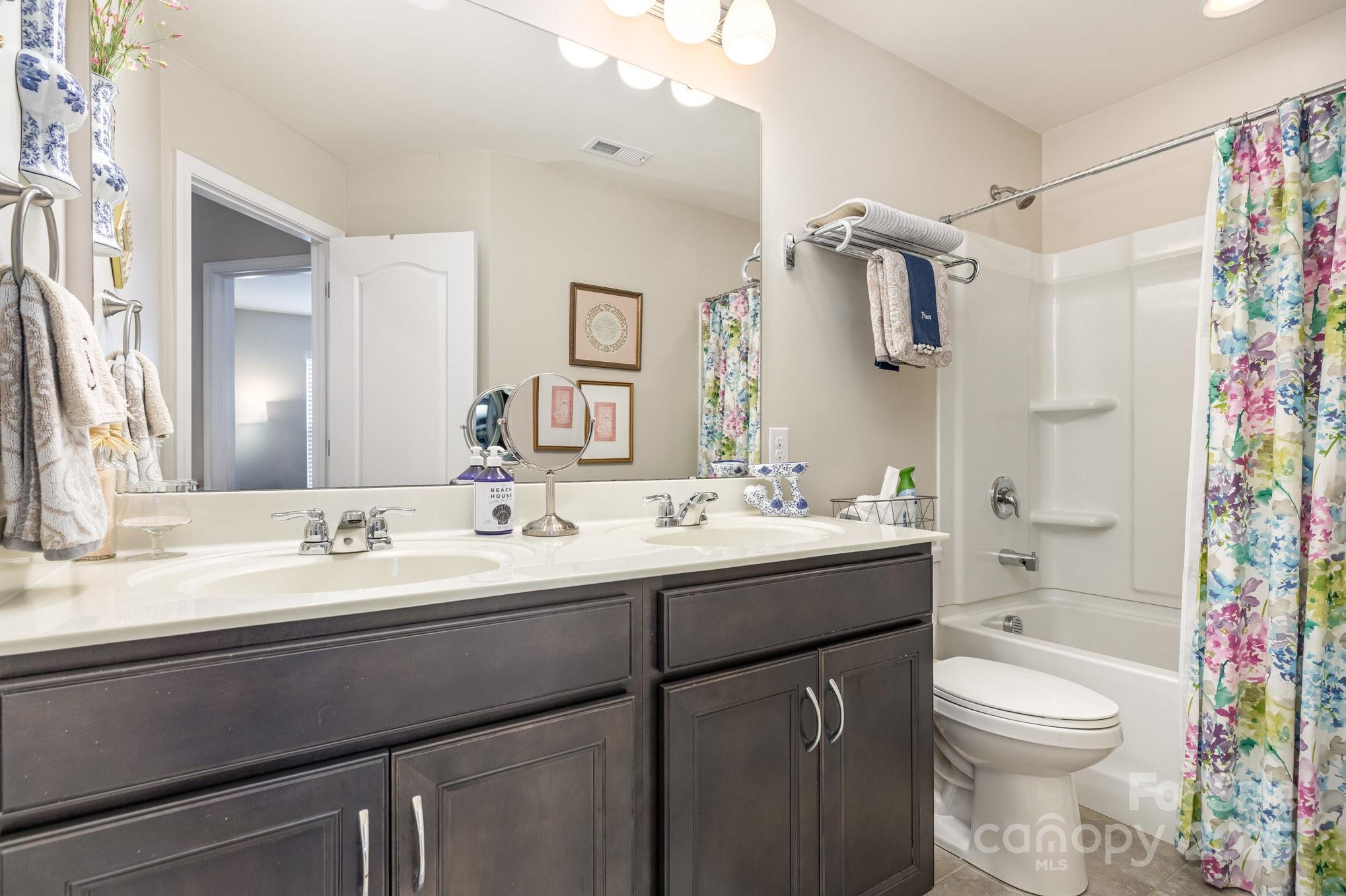 6006 Cadence Lane Fort Mill, SC 29707 - Photo 16 of 19 a bathroom with a sink toilet double vanity and shower