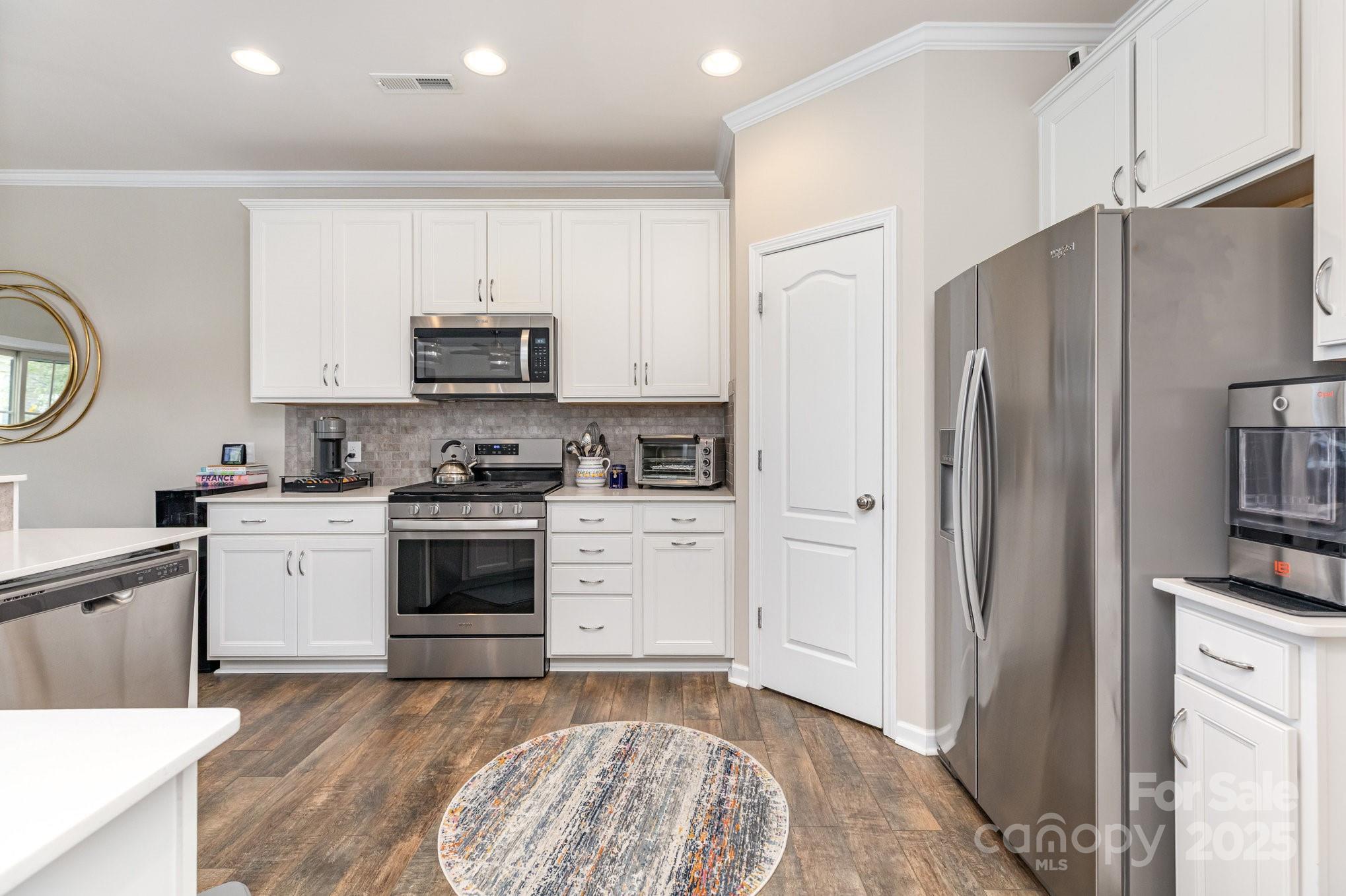 6006 Cadence Lane Fort Mill, SC 29707 - Photo 6 of 19 a kitchen with granite countertop a refrigerator stove and a sink