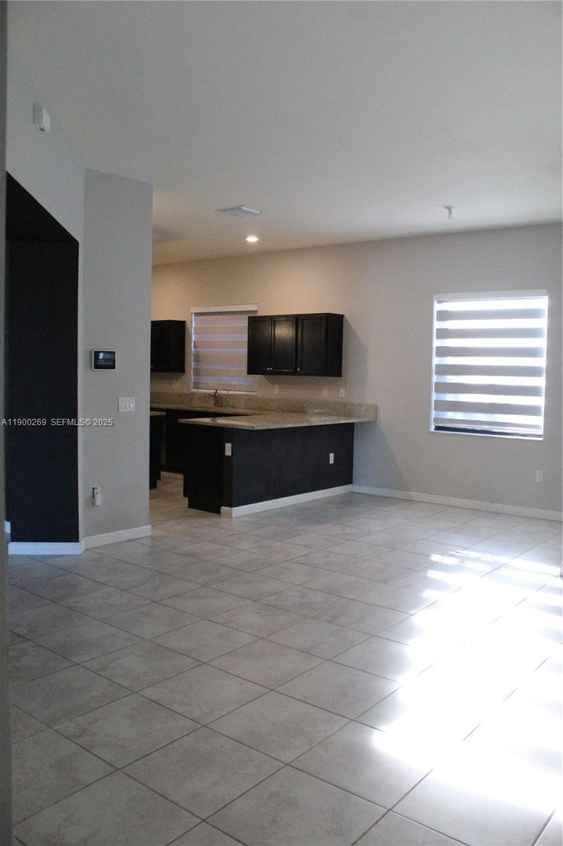 25096 Southwest 118th Avenue, Unit 25096 Homestead, FL 33032 - Photo 12 of 78 a view of kitchen and microwave