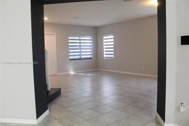 a front view of multiple houses with yard