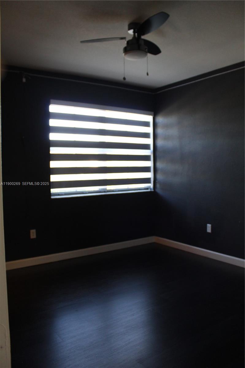 25096 Southwest 118th Avenue, Unit 25096 Homestead, FL 33032 - Photo 38 of 78 a view of room with hardwood floor and a ceiling fan