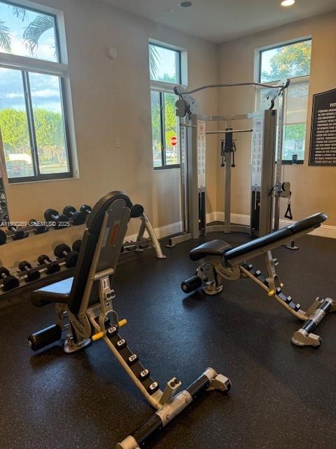 25096 Southwest 118th Avenue, Unit 25096 Homestead, FL 33032 - Photo 70 of 78 a room with gym equipment and a large window