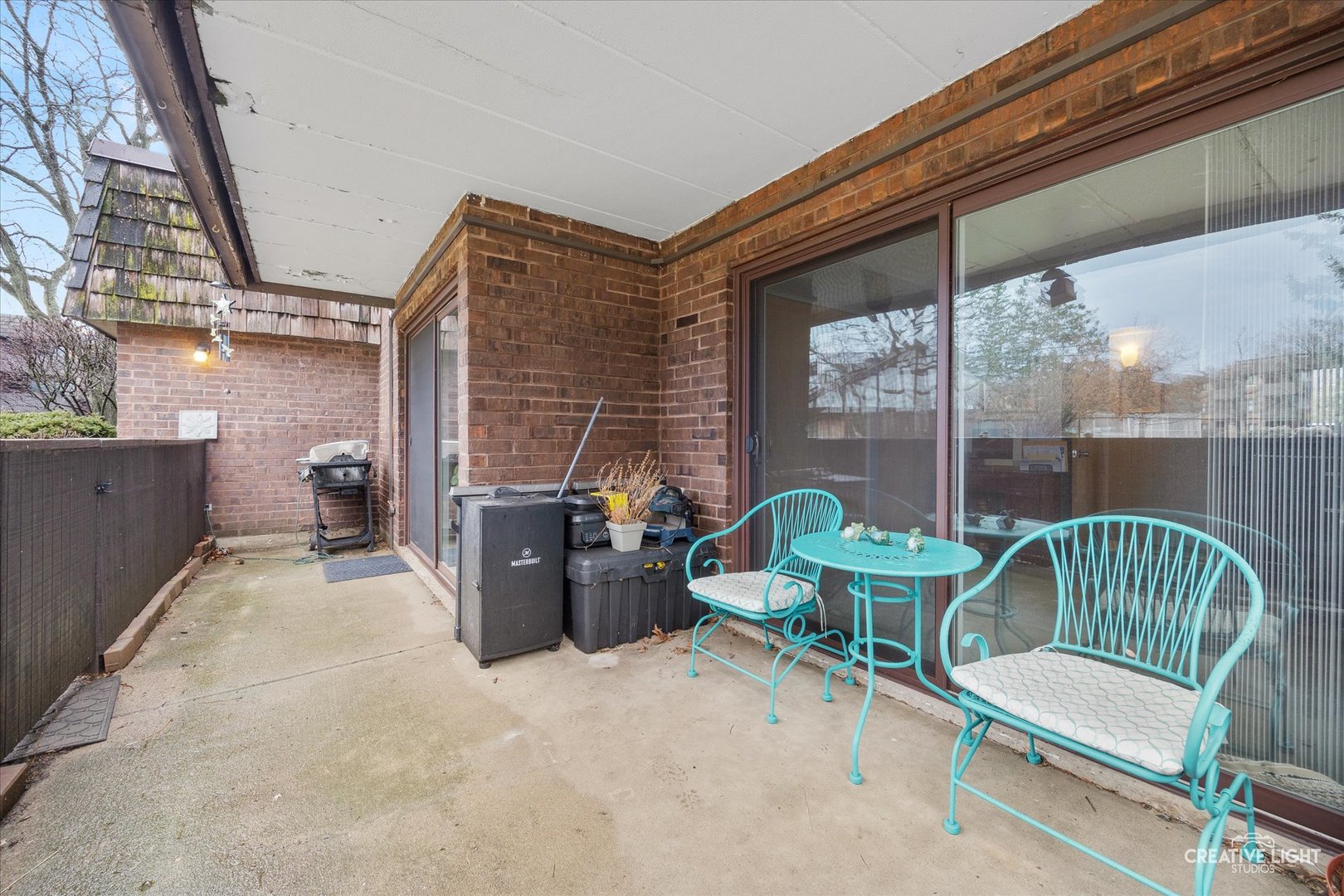 491 Timber Ridge Drive, Unit 102 Carol Stream, IL 60188 - Photo 13 of 18 a view of a patio with a table and chairs