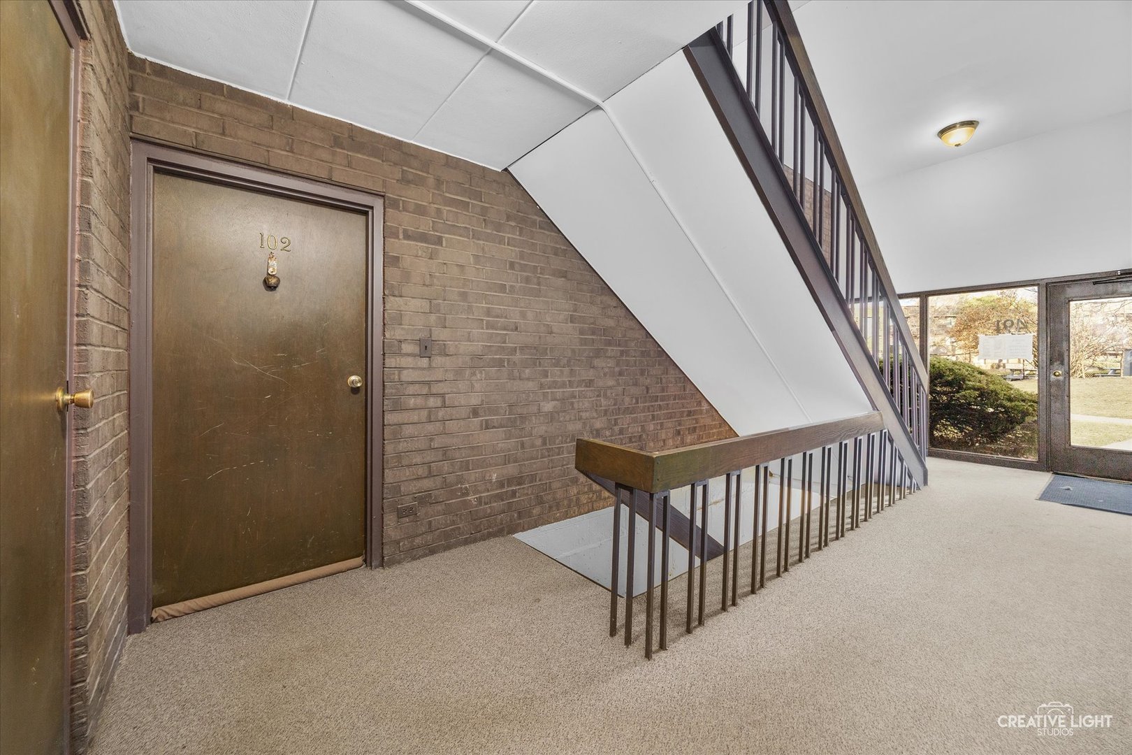 491 Timber Ridge Drive, Unit 102 Carol Stream, IL 60188 - Photo 15 of 18 a view of staircase with railing and door