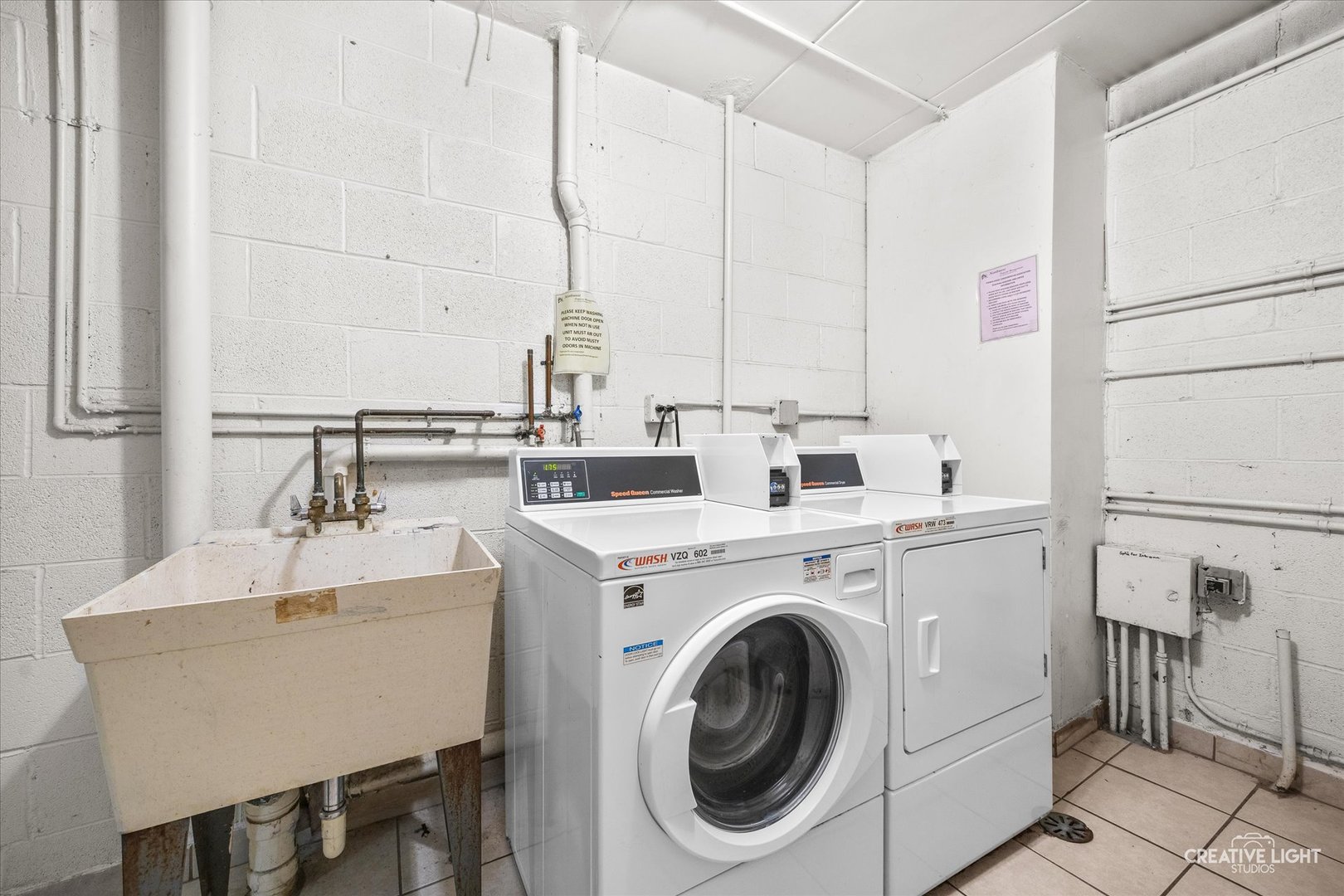 491 Timber Ridge Drive, Unit 102 Carol Stream, IL 60188 - Photo 16 of 18 a view of washer and dryer with bathroom in the background