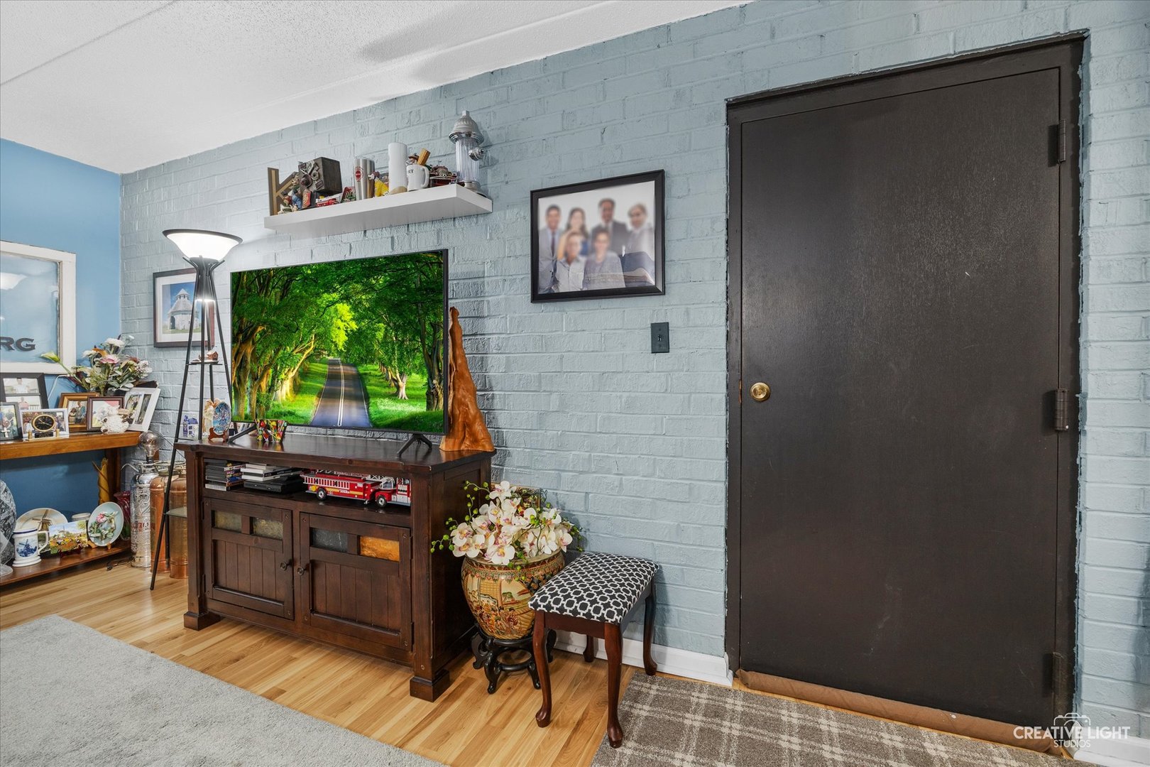 491 Timber Ridge Drive, Unit 102 Carol Stream, IL 60188 - Photo 3 of 18 a living room with furniture and a flat screen tv
