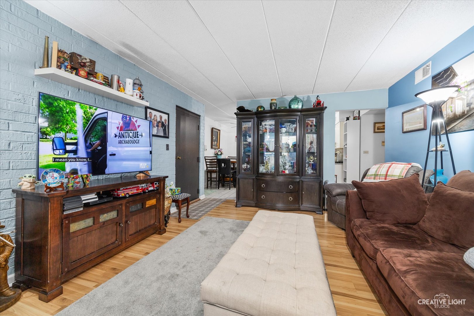 491 Timber Ridge Drive, Unit 102 Carol Stream, IL 60188 - Photo 5 of 18 a living room filled with furniture and a flat screen tv