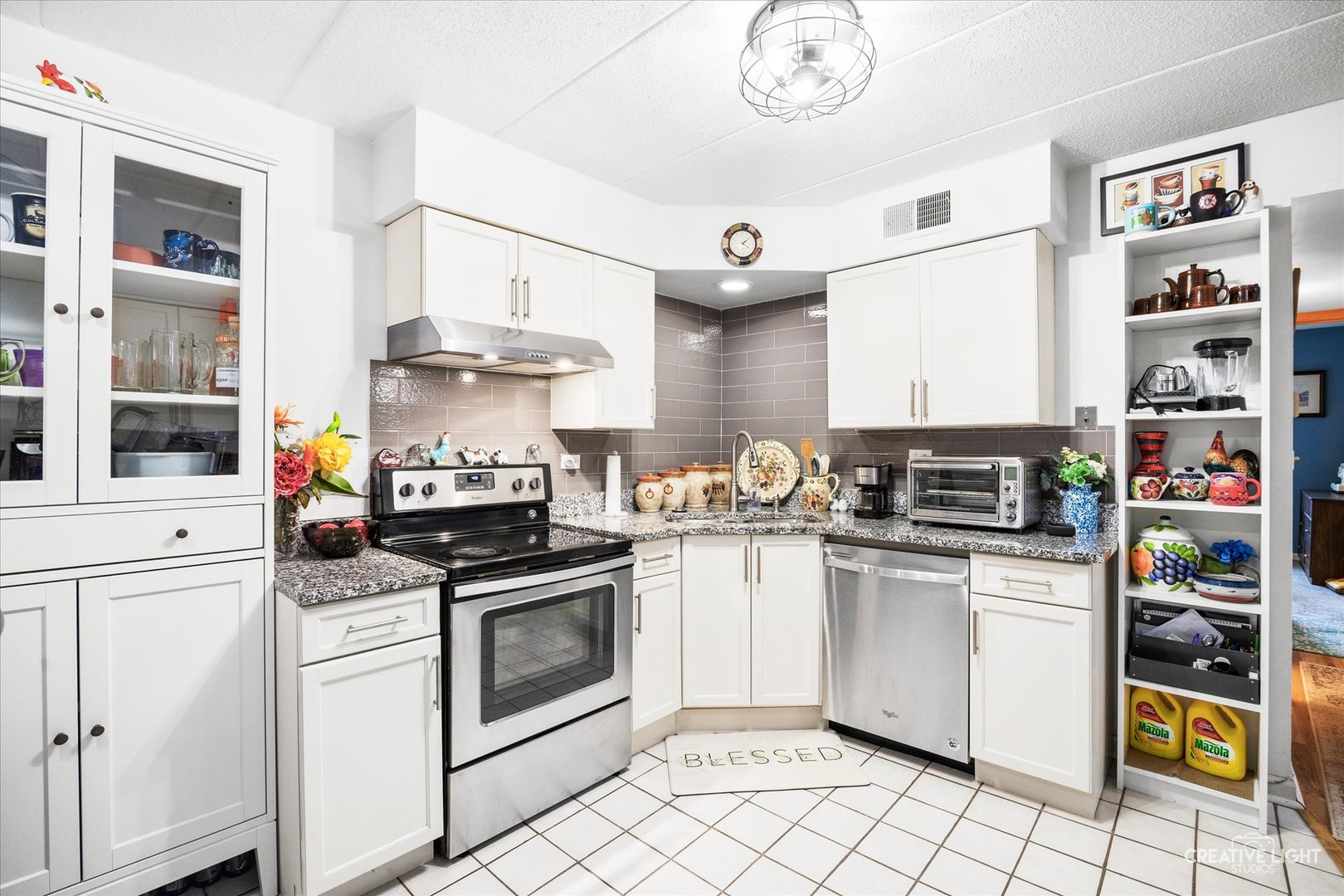491 Timber Ridge Drive, Unit 102 Carol Stream, IL 60188 - Photo 6 of 18 a kitchen with stainless steel appliances granite countertop a stove and a cabinets
