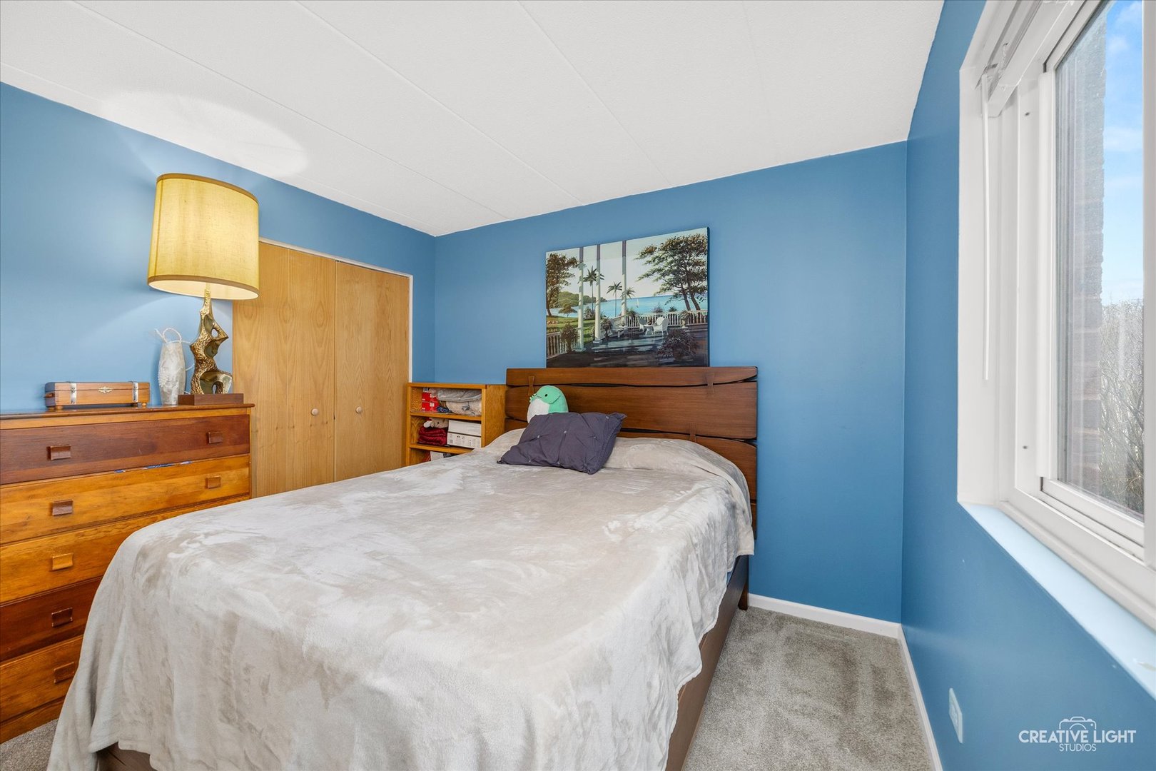 491 Timber Ridge Drive, Unit 102 Carol Stream, IL 60188 - Photo 10 of 18 a bedroom with a bed and wooden floor