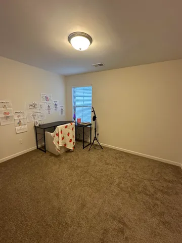 a bed room with a bed and a lamp