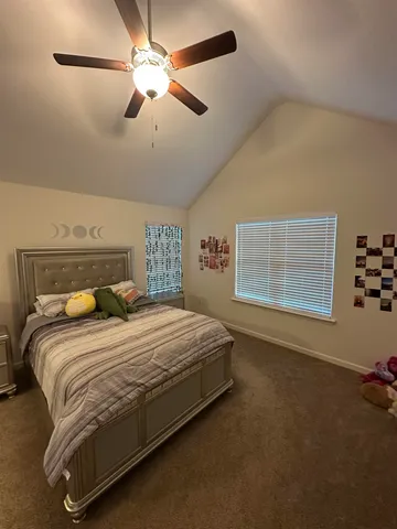 a bedroom with a bed and a ceiling fan
