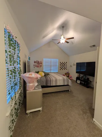 a bedroom with bed and a chandelier