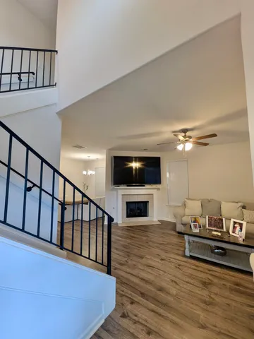 a living room with furniture a flat screen tv and a fireplace
