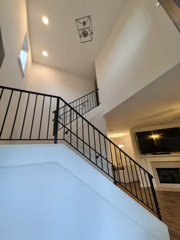 a view of staircase with lots of frames on wall
