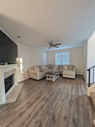 a living room with furniture a fireplace and a flat screen tv