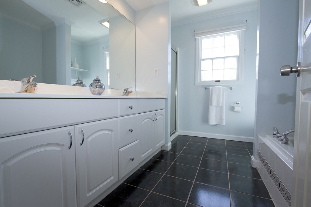 2 Campbell Road Middleton, MA 01949 - Photo 14 of 30 a bathroom with a double vanity sink a mirror and a shower