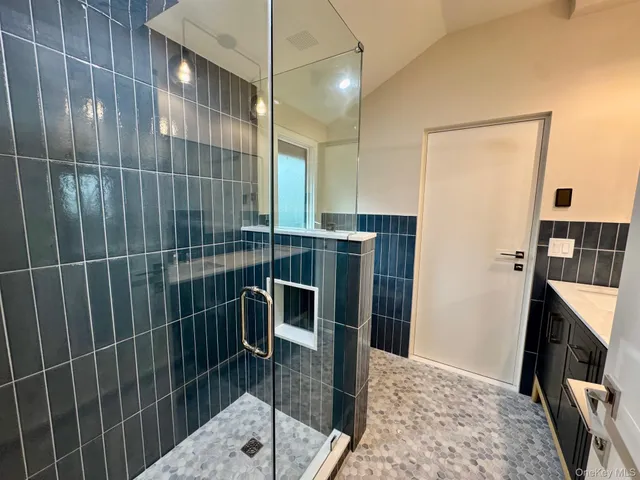 a view of a kitchen with a sink and a refrigerator