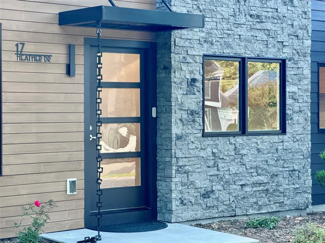 a view of front door of house with wooden floor and a yard