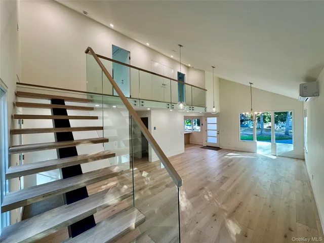 a living room with a bed furniture and a window