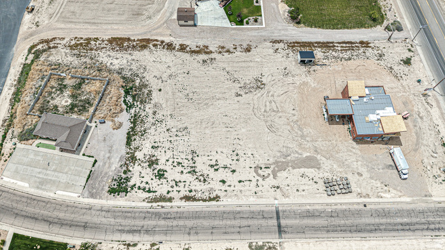 84 White Sage Avenue, Unit 2 Delta, UT 84624 - Photo 18 of 18 Expansive vacant lot featuring a partially constructed structure with roofing materials
