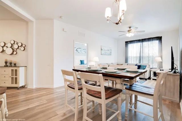 a view of a dining room with furniture and wooden floor