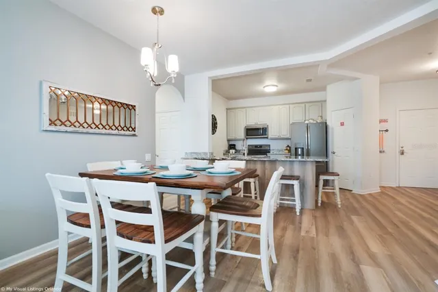 a kitchen with granite countertop lots of white cabinets and stainless steel appliances