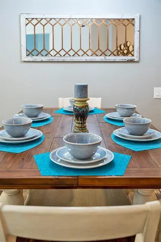 a view of a dining room with furniture a rug and wooden floor