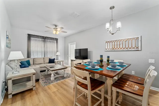 a living room with furniture a table and chairs
