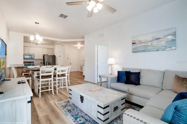 a living room with furniture and a chandelier