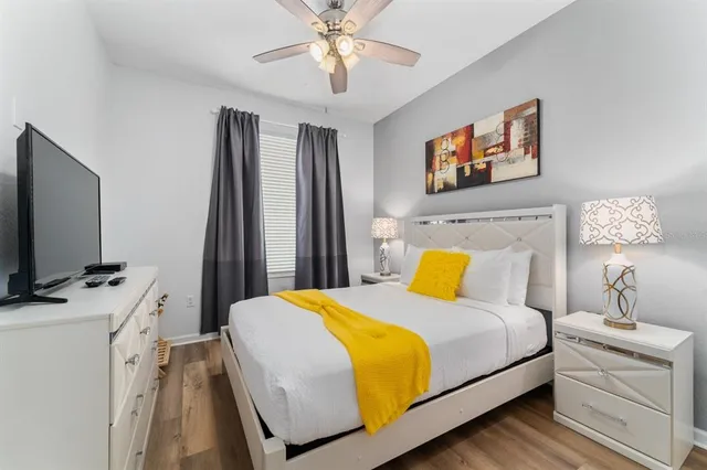 a bathroom with a granite countertop toilet a sink and a mirror