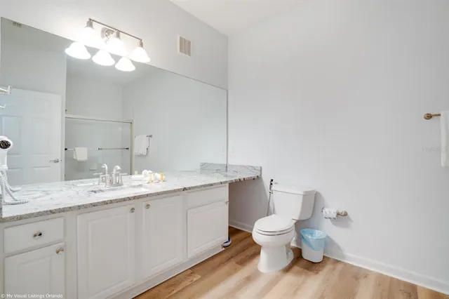 a bathroom with a glass shower door