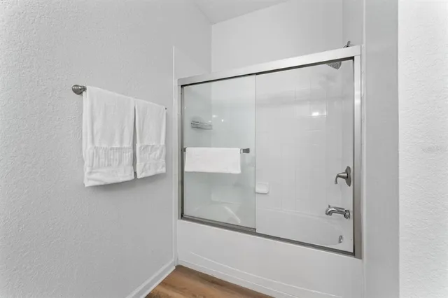 a bathroom with a granite countertop sink a toilet and a mirror