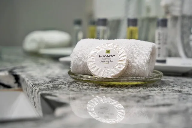 a bedroom with bed tv and wooden floor