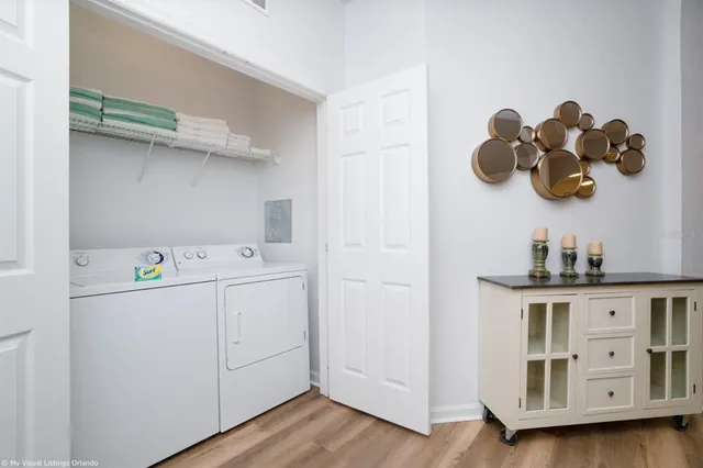 a living room with furniture a flat screen tv and kitchen view