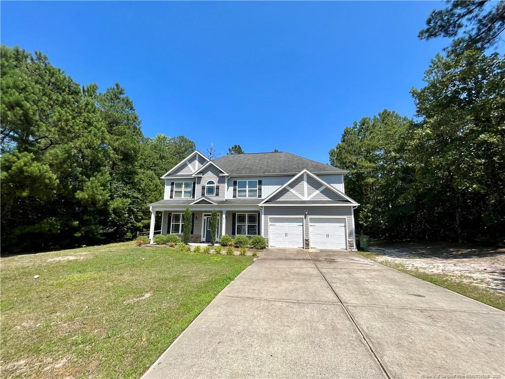54 Inlet View Sanford, NC 27332 - Photo 2 of 25 a front view of a house with a garden