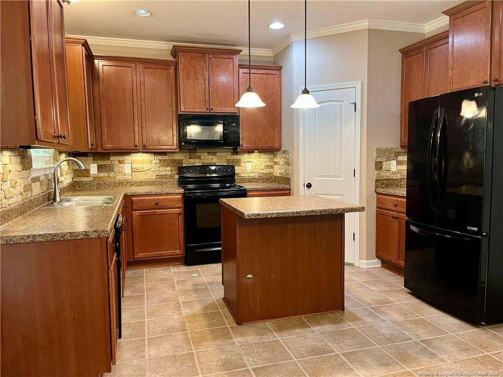54 Inlet View Sanford, NC 27332 - Photo 9 of 25 a kitchen with stainless steel appliances granite countertop a refrigerator a sink and a stove