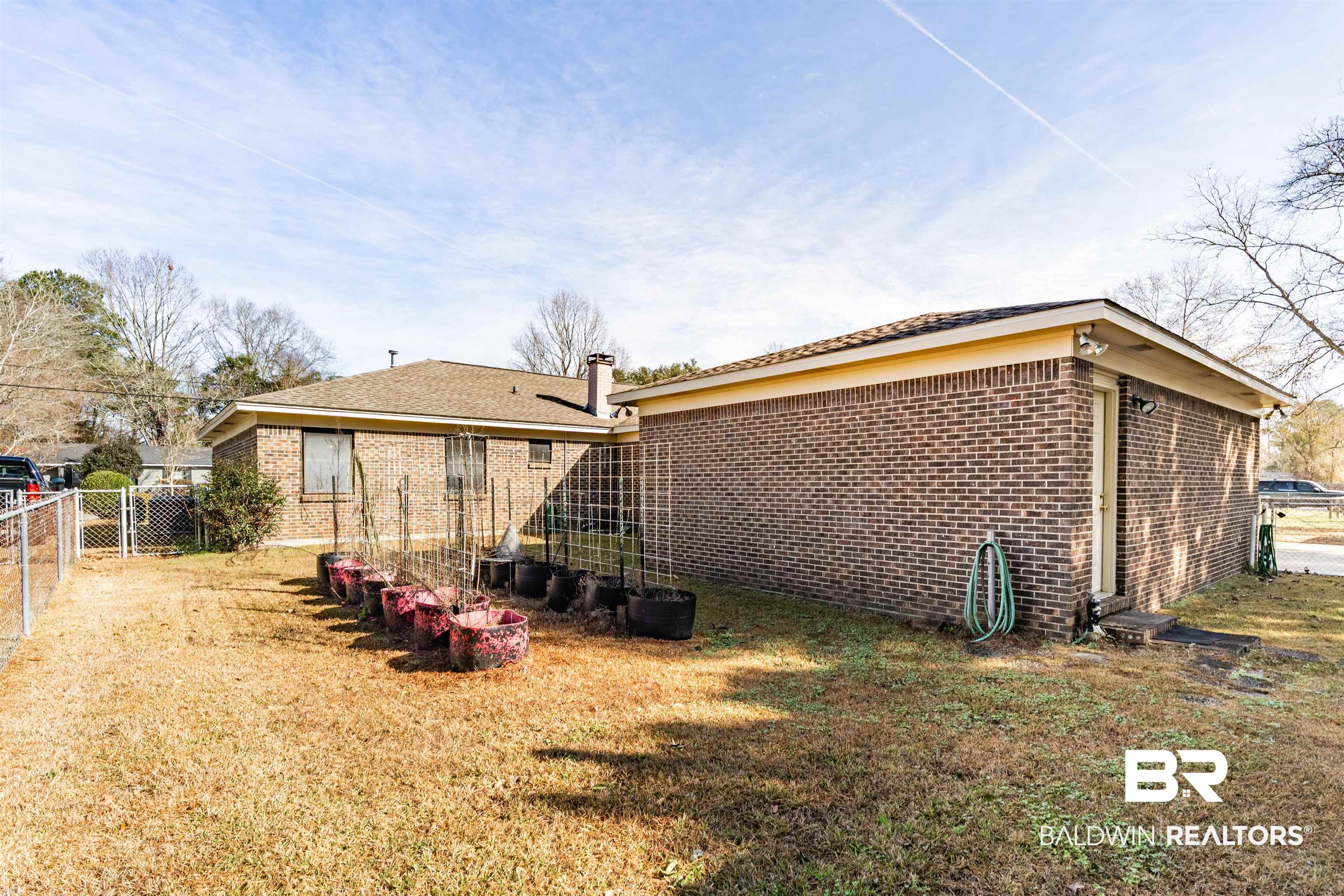 9751 Pine Knoll Road Mobile, AL 36608 - Photo 30 of 36 Back of property featuring brick siding and a fenced backyard